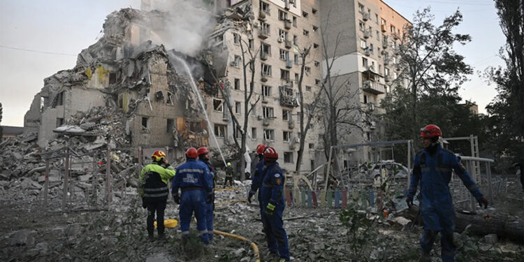 Rescuers extinguish a fire in a damaged residential building following Russian missile and drone strikes. By Genya Savilova/AFP/Getty Images