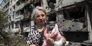A woman with her cat in Pavlohrad after a Russian attack. Source: Reuters