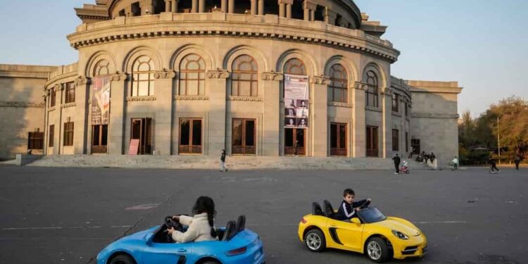Children ride toy cars in Freedom Square in Yerevan in November 2021. Source: AP Photo/Pavel Golovkin